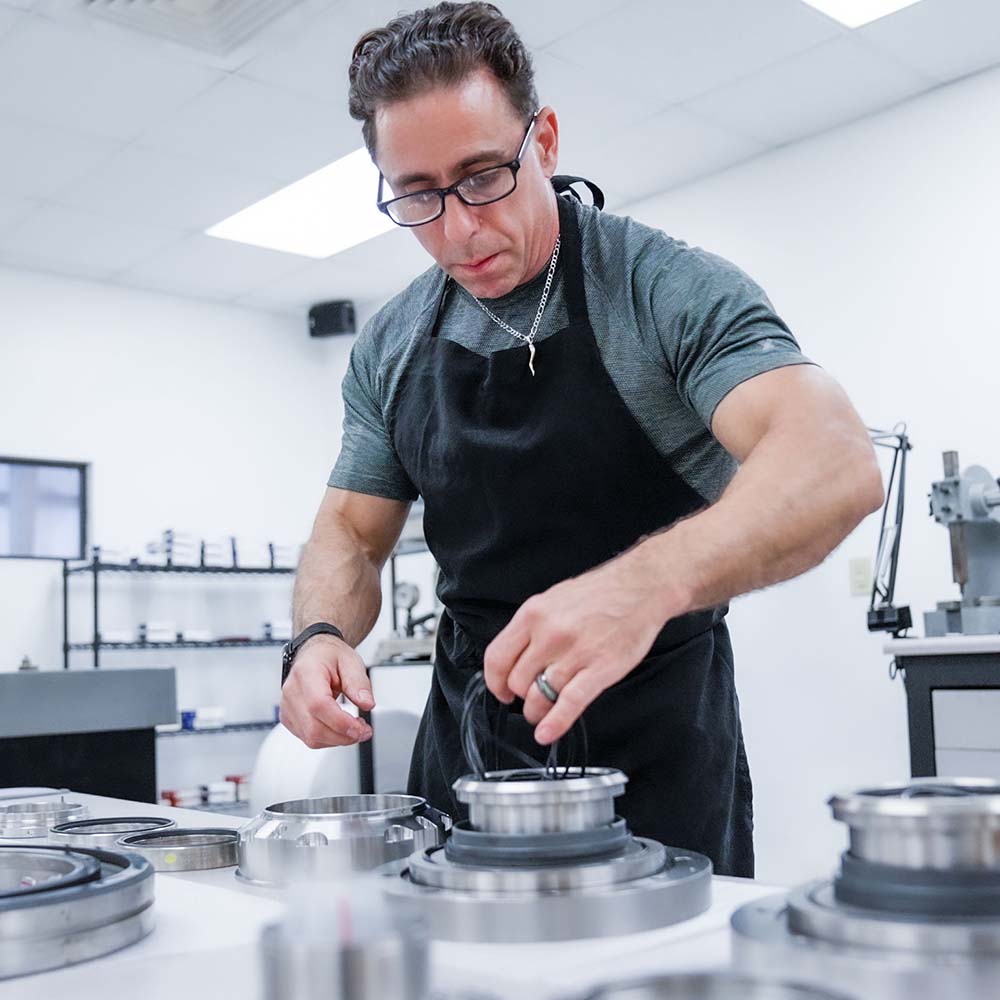 A man working on vacuum pump and blower repair for DanHart, LLC.