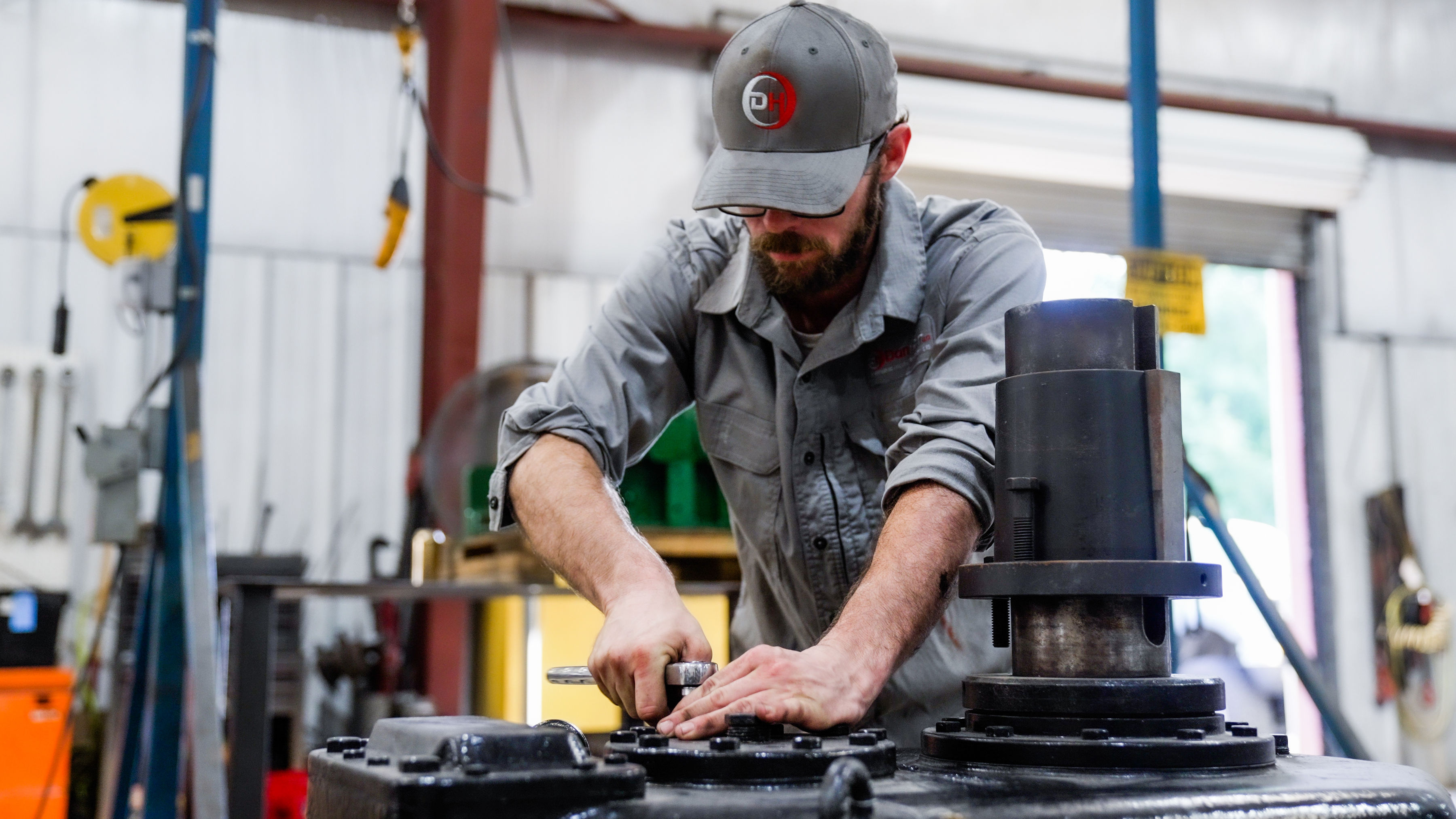 A man working on vacuum pump and blower repair for DanHart, LLC.