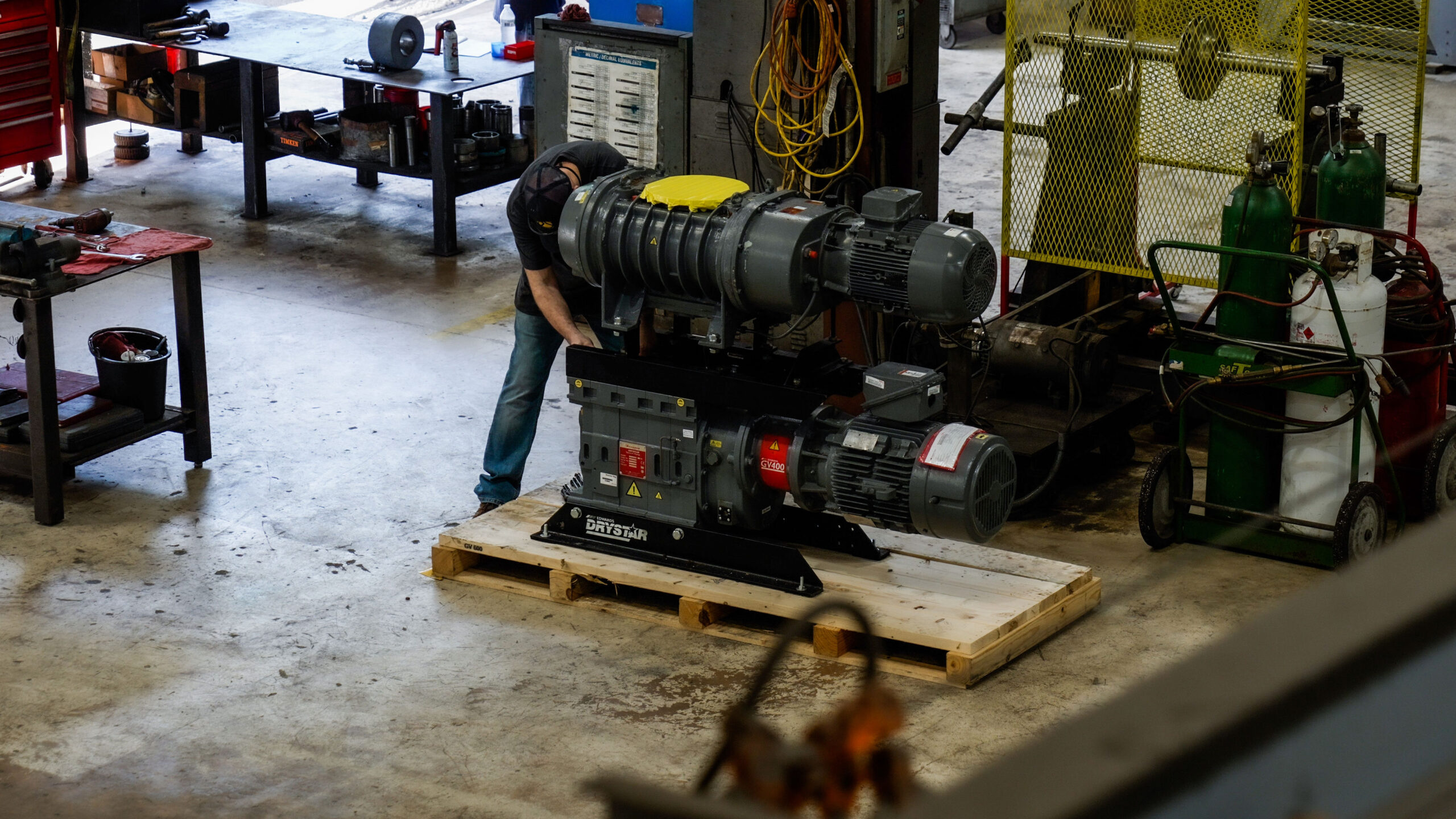 A man working on vacuum pump and blower repair for DanHart, LLC.